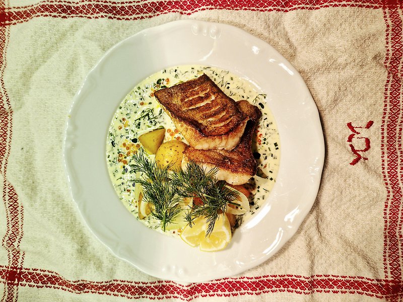 En tallrik med stekt fisk och potatis